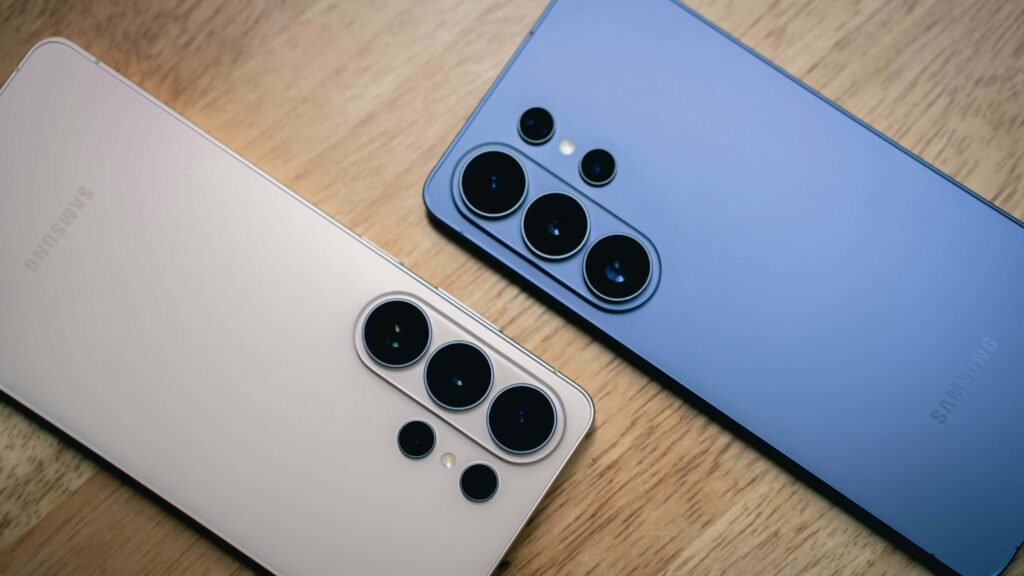 Samsung Galaxy Ultra phones in silver and blue side-by-side on wooden surface displaying rear cameras
