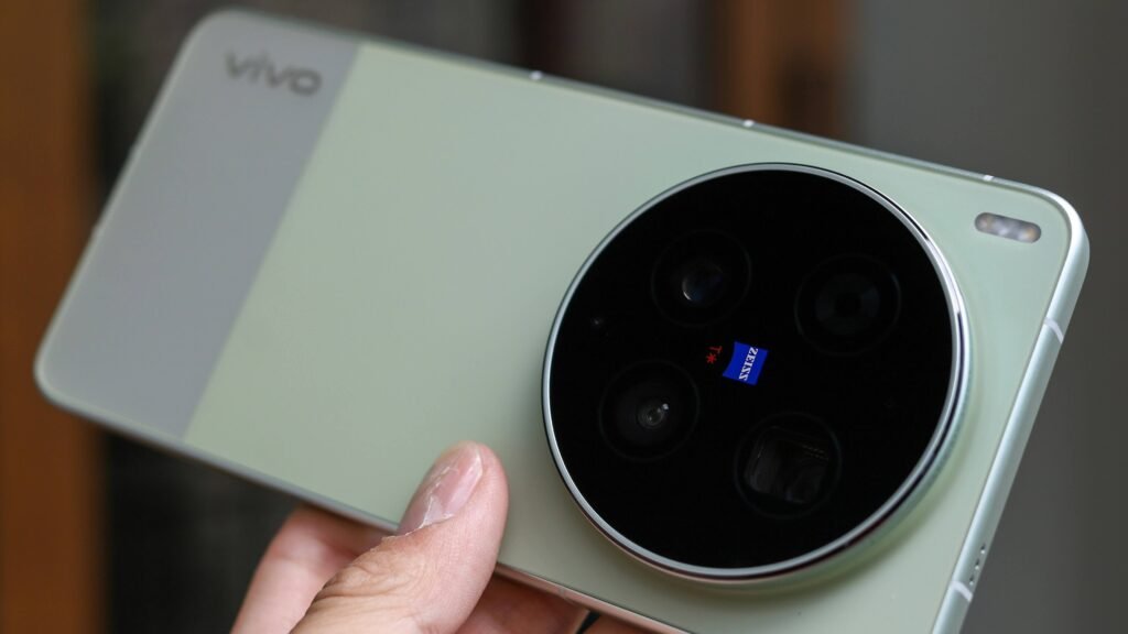 Hand holding green Vivo smartphone showing large circular ZEISS camera lens ring
