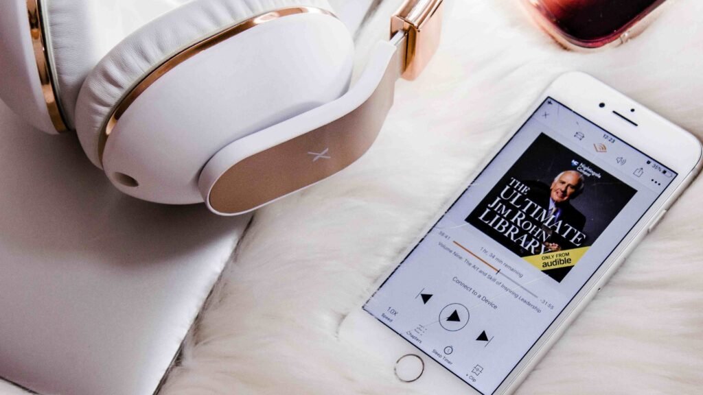 Best audiobook apps featuring Audible player interface on a smartphone with headphones