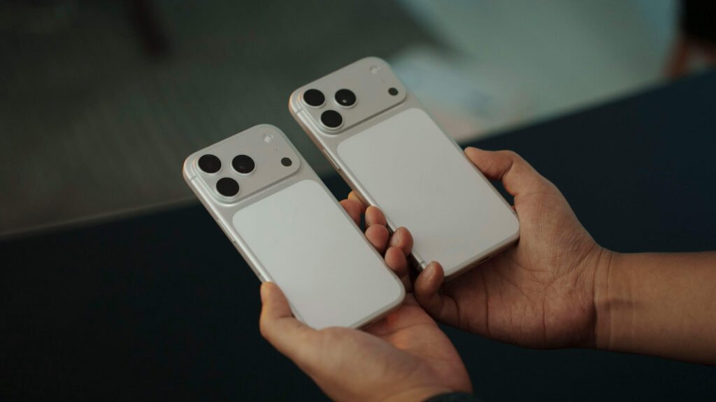 Hands holding iPhone 17 Pro models with horizontal camera bar for best phones for photography guide